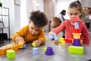 Two young children playing with toys on a table — representing the state of U.S. childhood health.